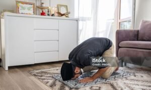Muslim man praying at home