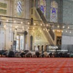 Muslim people praying in the Blue Mosque in Istanbul, Turkey.